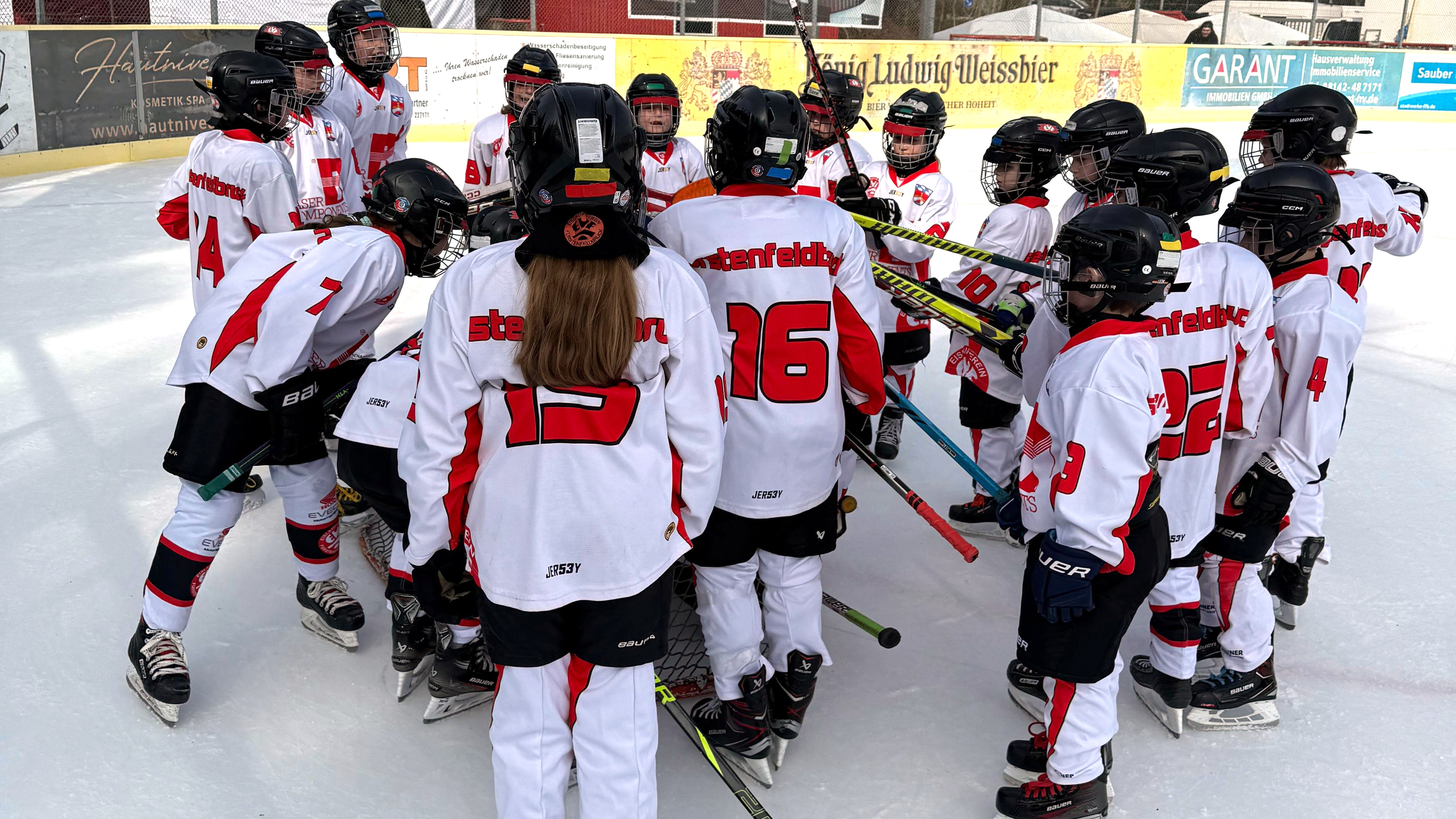 Spieler der U9 des EVF versammeln sich im Eisstadion der Amperoase um ihr Tor.